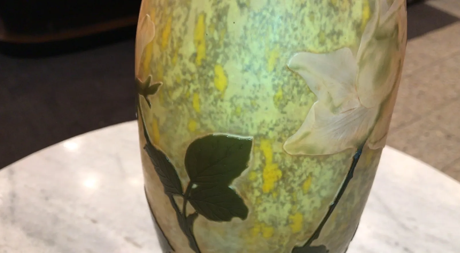 Antique signed glass by Daum Nancy featuring floral designs in a cozy setting.