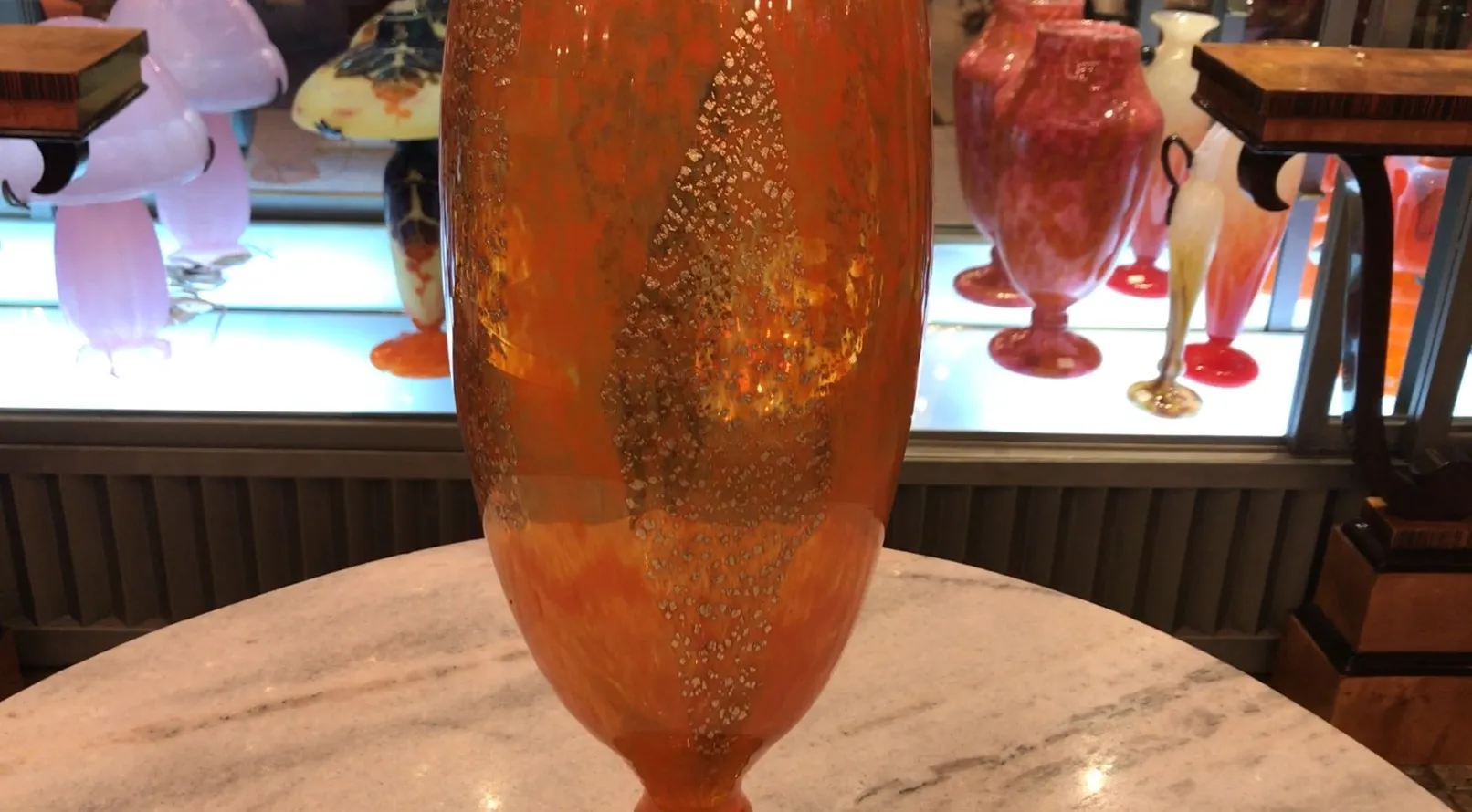 Antique vase with signature, bright orange color, gold details.