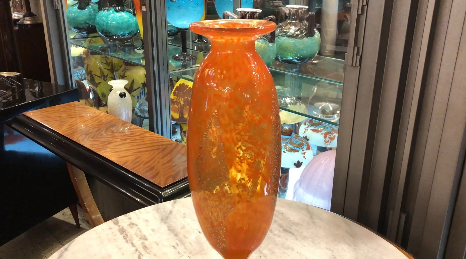 Antique signed glass Daum Nancy in orange on display