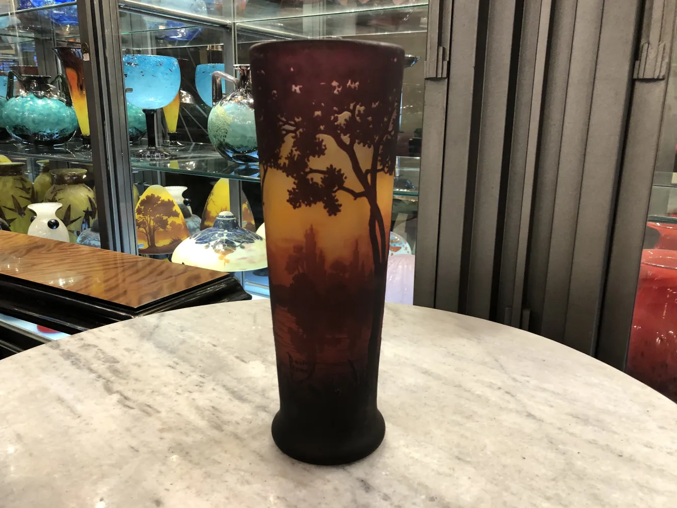 Pieza de vidrio con diseño colorido y árboles en la decoración