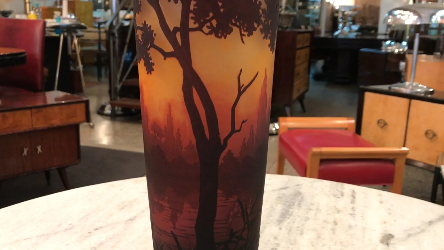 antique glass with landscape, tree silhouette in warm tones