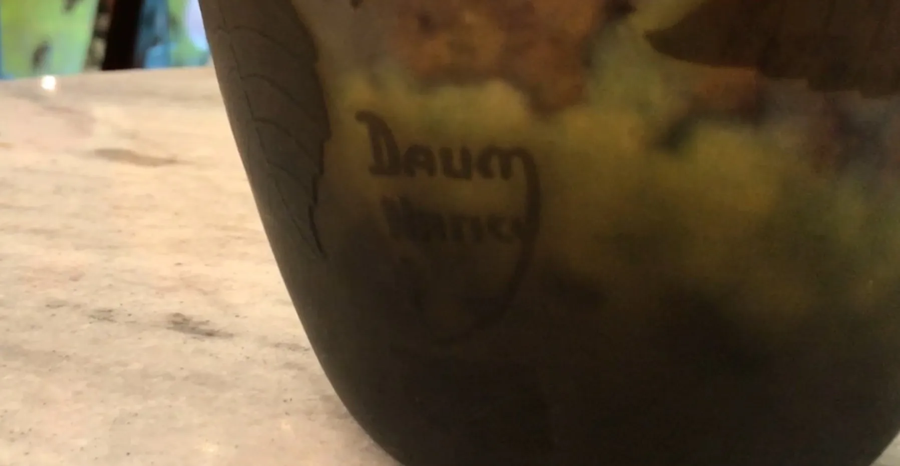 Antique signed glass Daum Nancy with visible signature, warm ambiance.