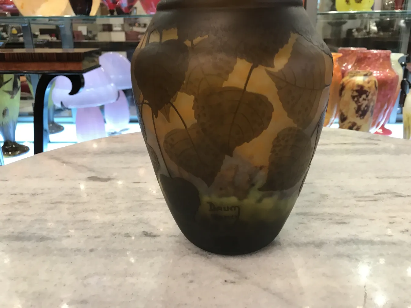 Decorative antique signed glass Daum Nancy with embossed leaves.