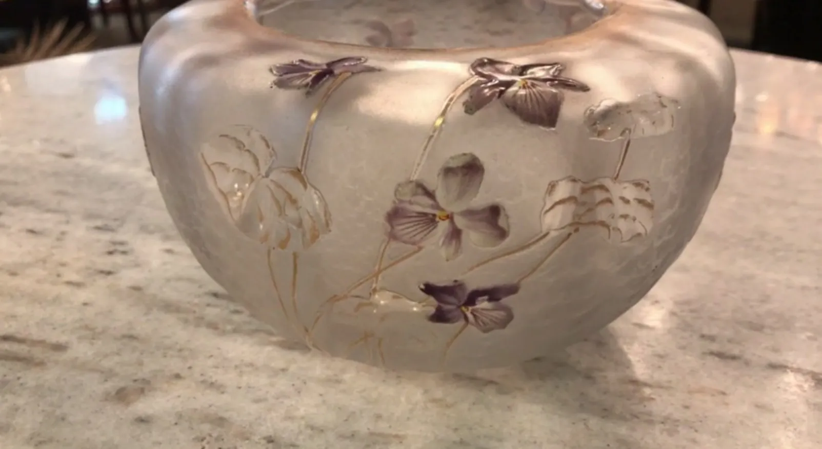 Vase in light colors with engraved purple flowers, elegant decor.