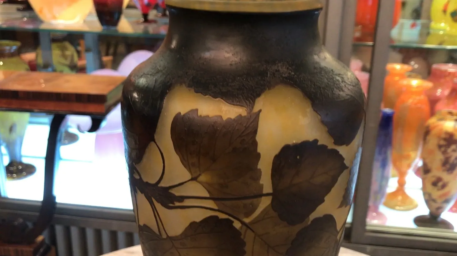 antique glass jar with leaf design, visible signature daum nancy, colorful background