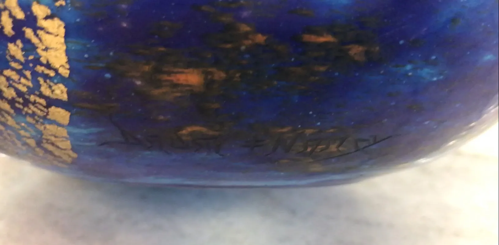 Signed glass Daum Nancy featuring vibrant colors and golden details.