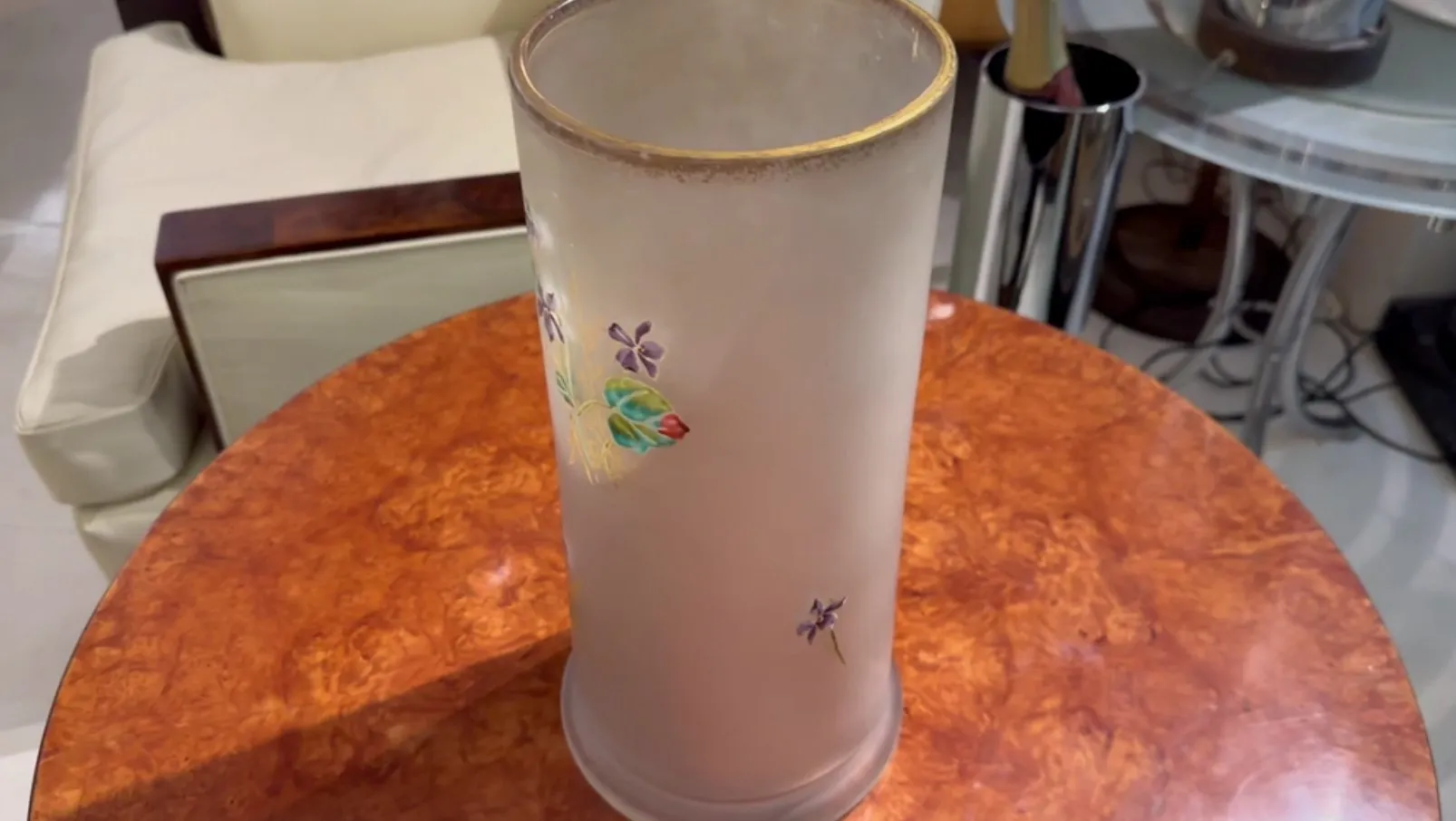 SIGNED GLASS Daum Nancy adorned with flowers in a cozy setting.