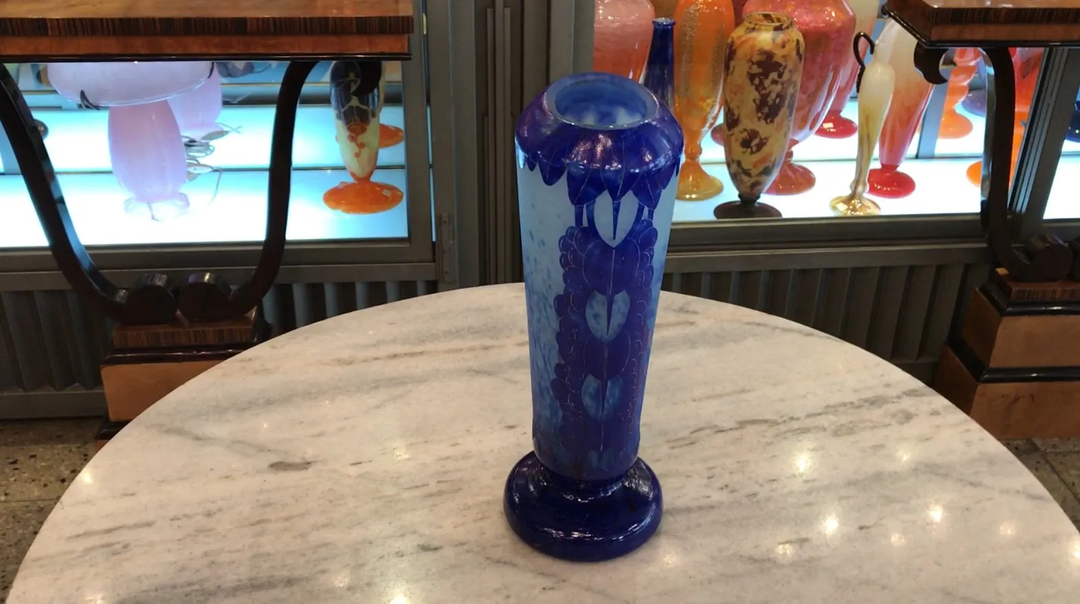 Elegant signed glass with blue details against a light background, in an antique setting