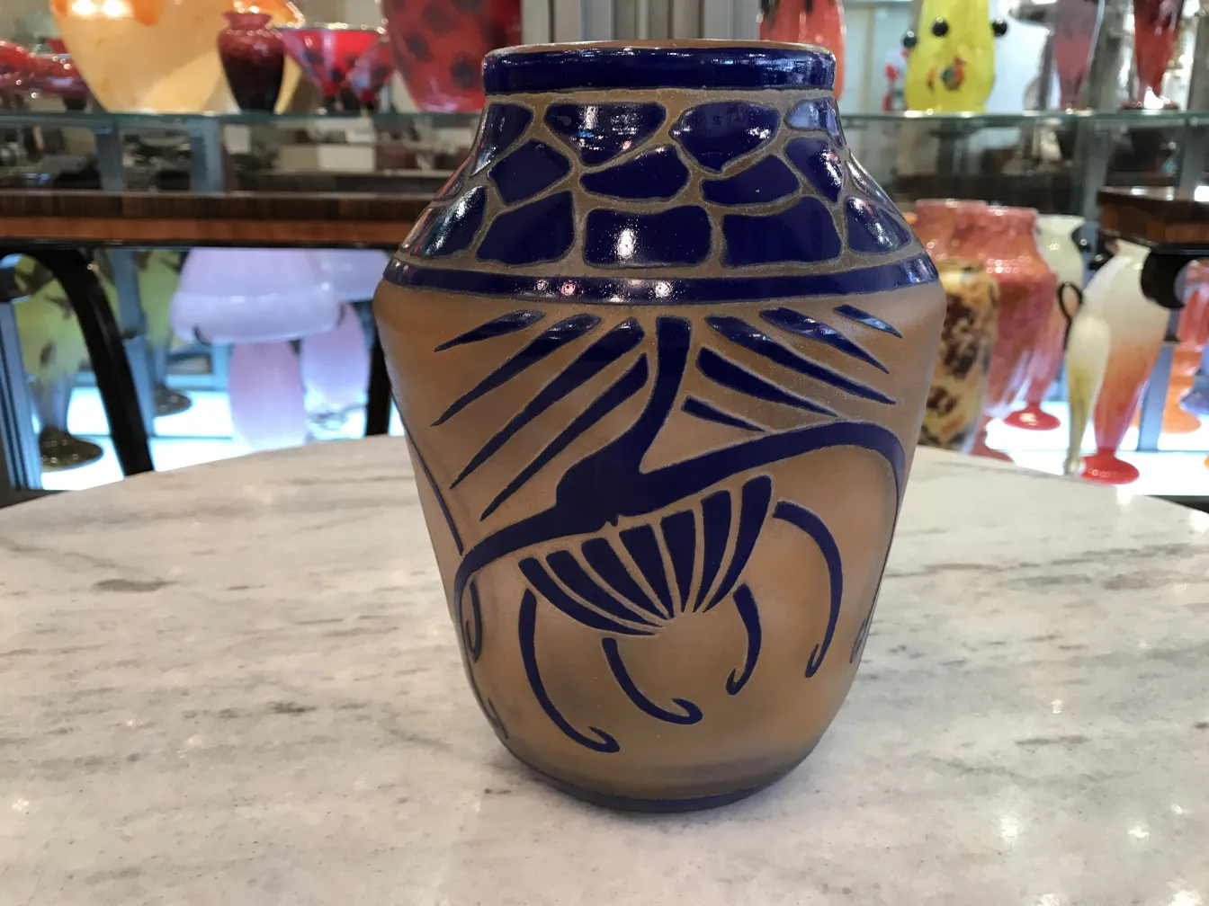 Antique vase with blue floral design and lines