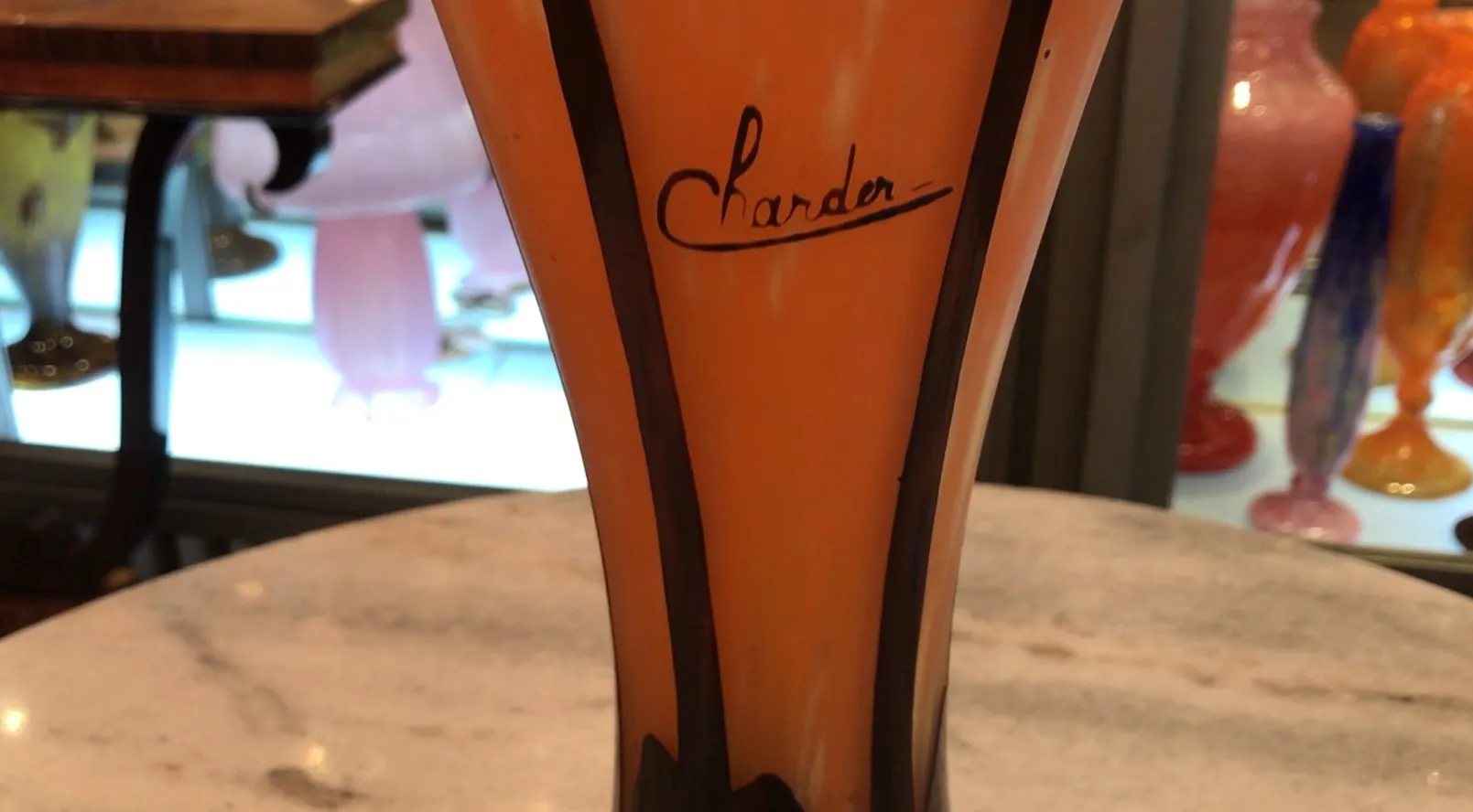 Antique signed glass by Charder with orange details, antique ambiance.