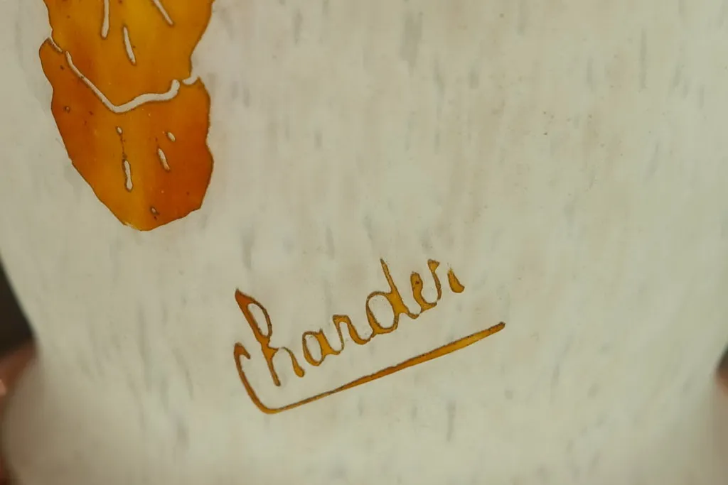 Verre ancien signé par Charder, décoré avec des motifs élégants, dans un cadre chic.