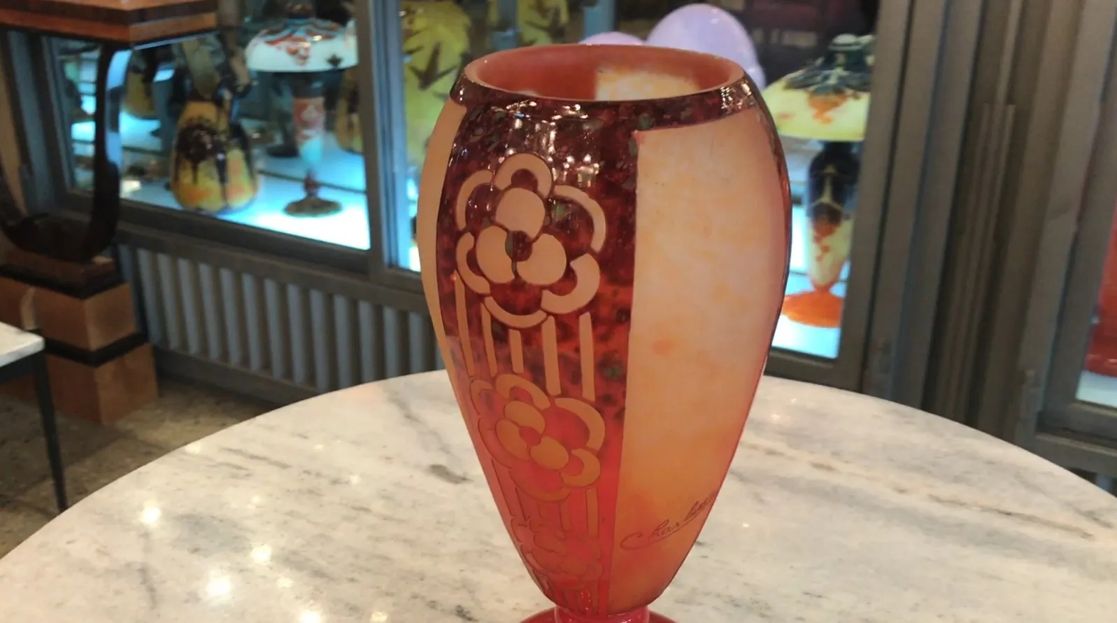 Antique signed Charder glass, floral design, on pedestal, with illuminated display background.