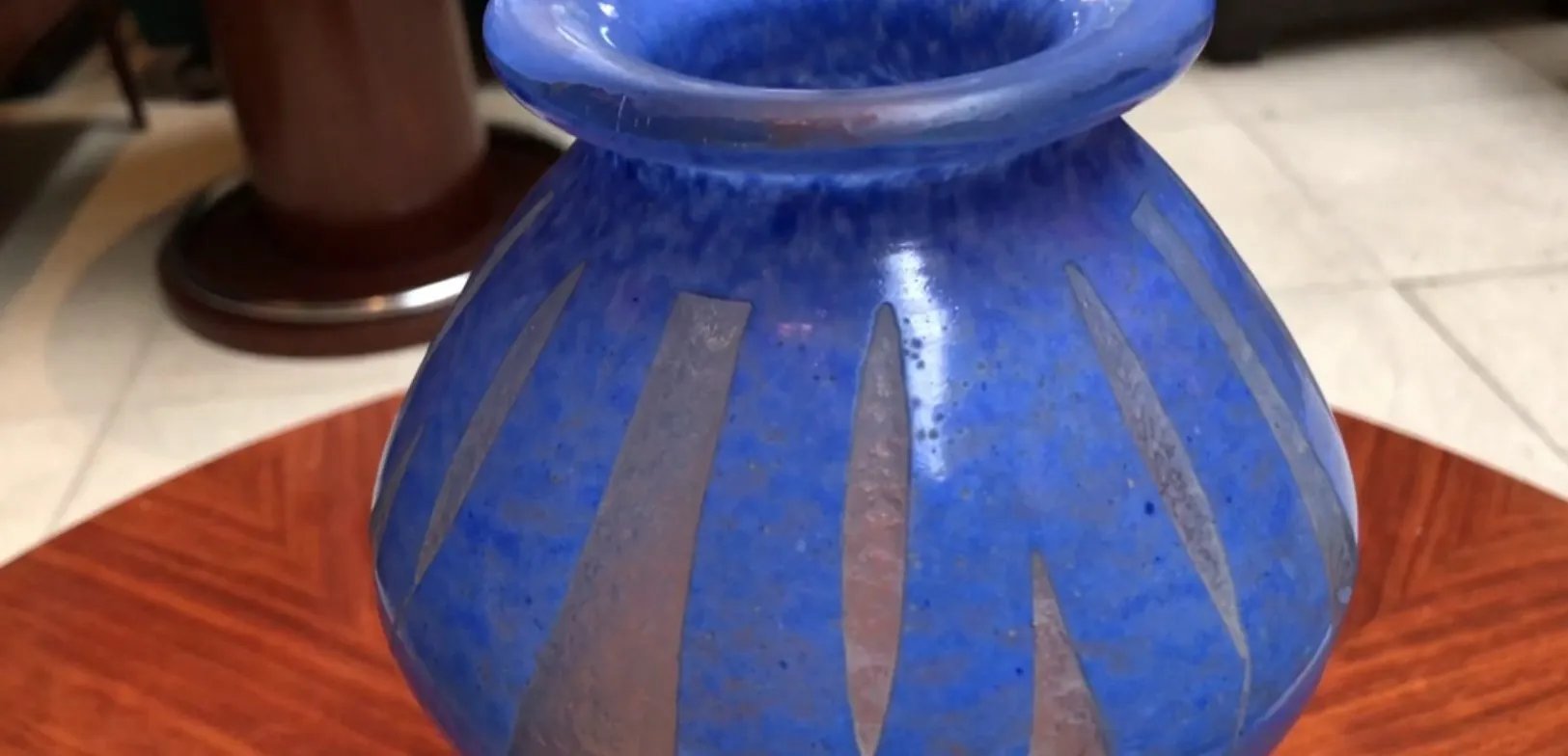 Antique blue glass vase signed Degué, decorated with stripes in an elegant environment.