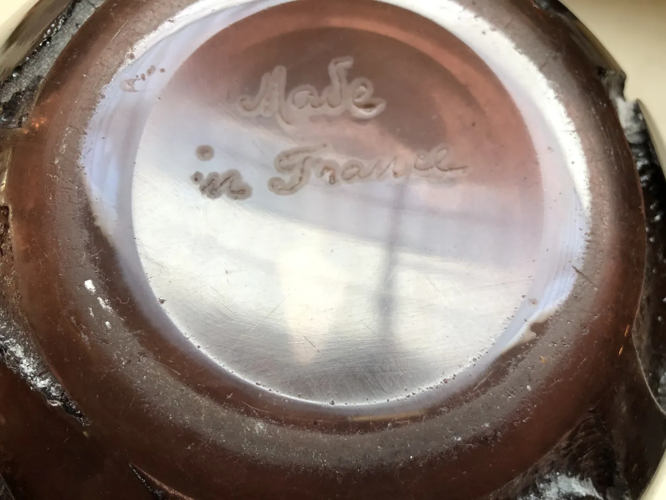Bottom view of a signed Degué glass, French antique, with inscription.