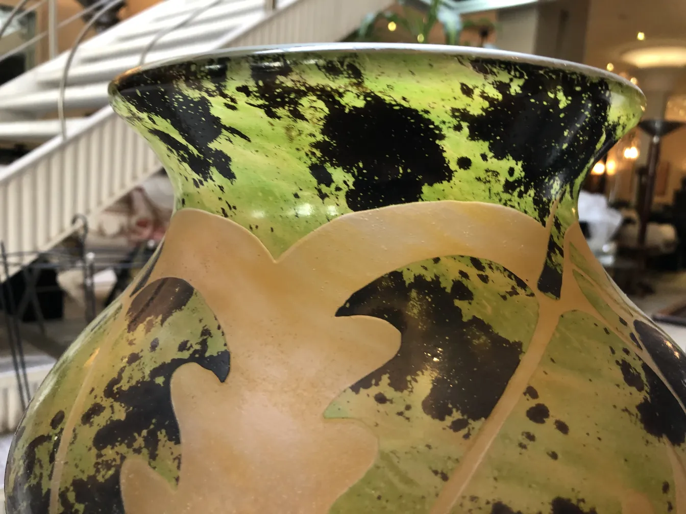 Side view of an antique signed glass Degué, featuring green and black colors.