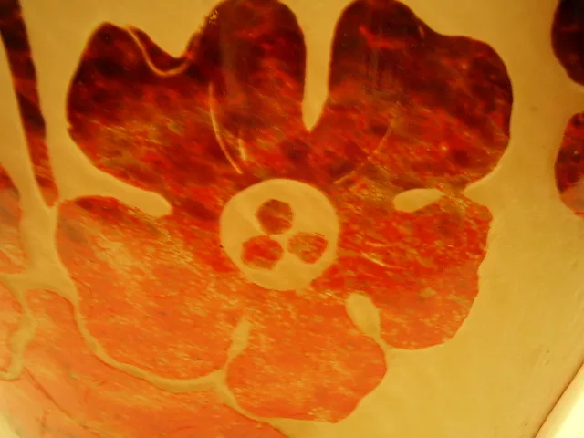 Signed glass Degué featuring a red flower design, antique.