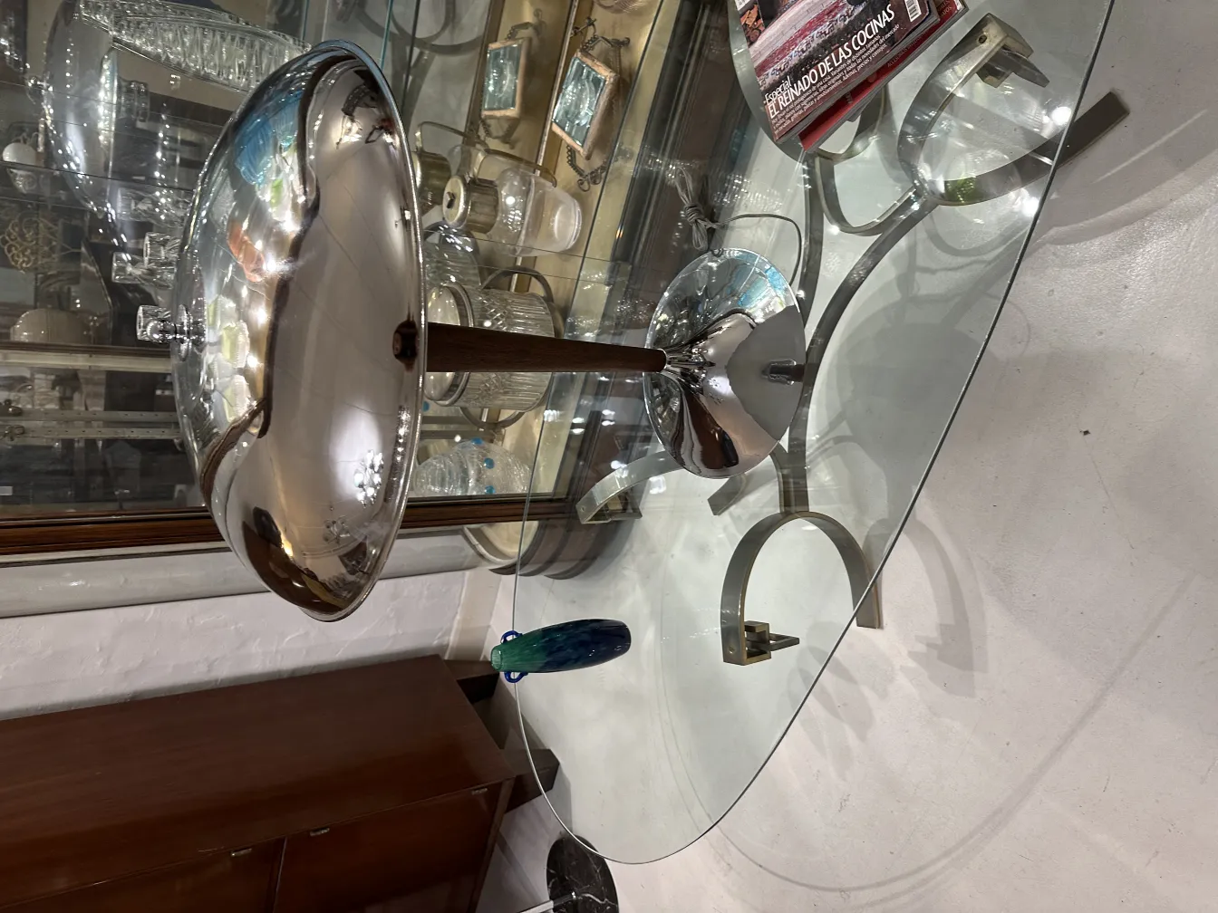 署名玻璃Degué反射光，周围有古董物品。