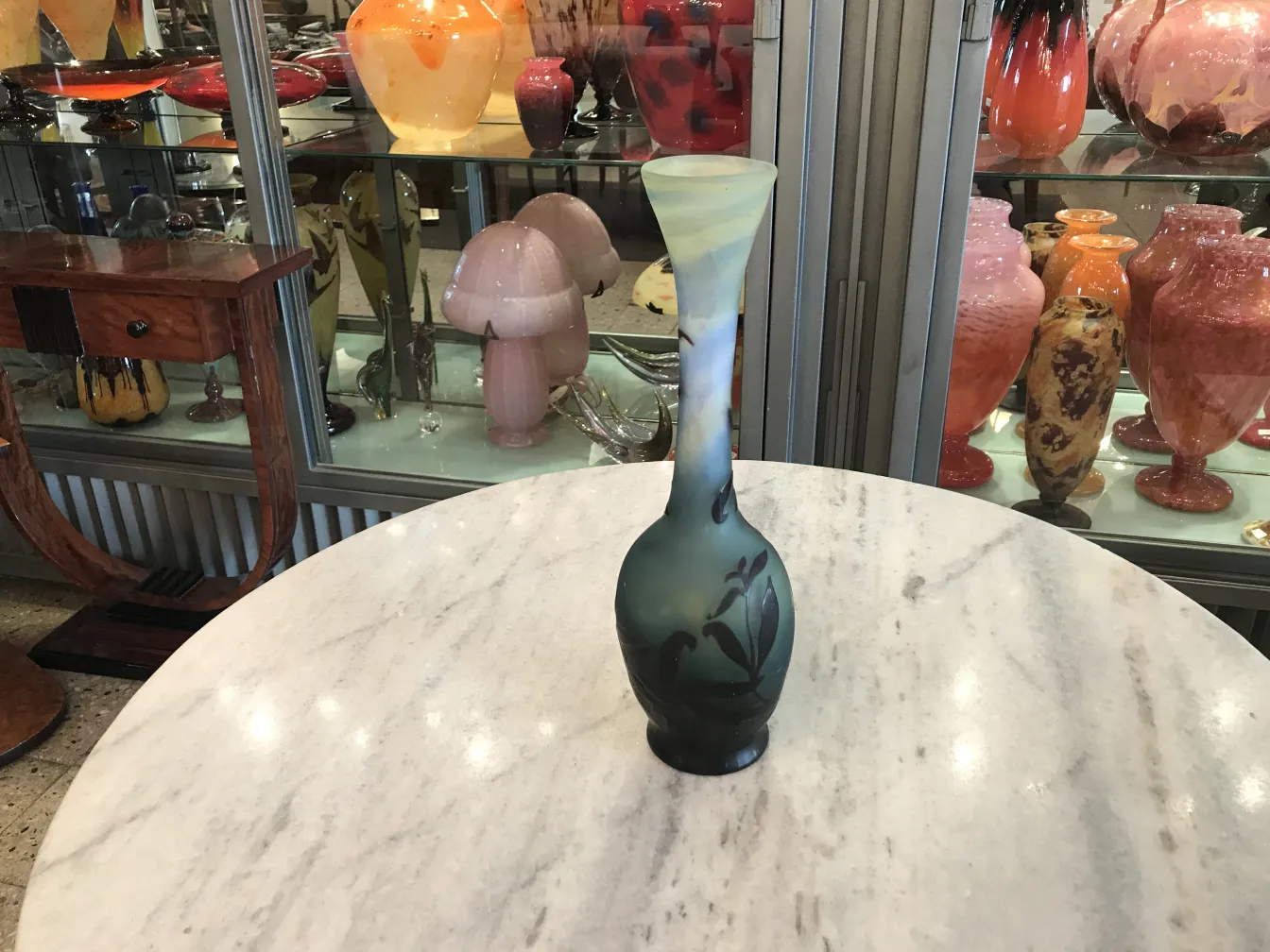 Antique signed glass Gallé vase with green decorations and dark flowers.