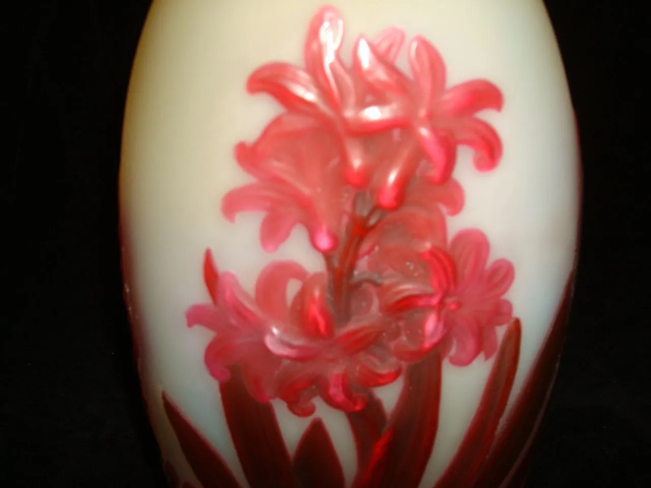 Glass signed Gallé with a floral design in red on a light background.