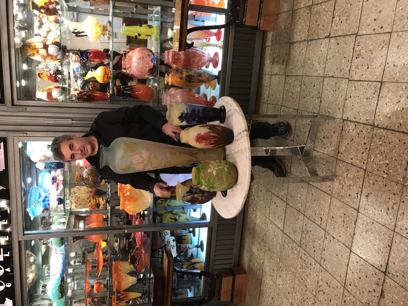 Antique Gallé signed vase displayed among colorful artifacts.