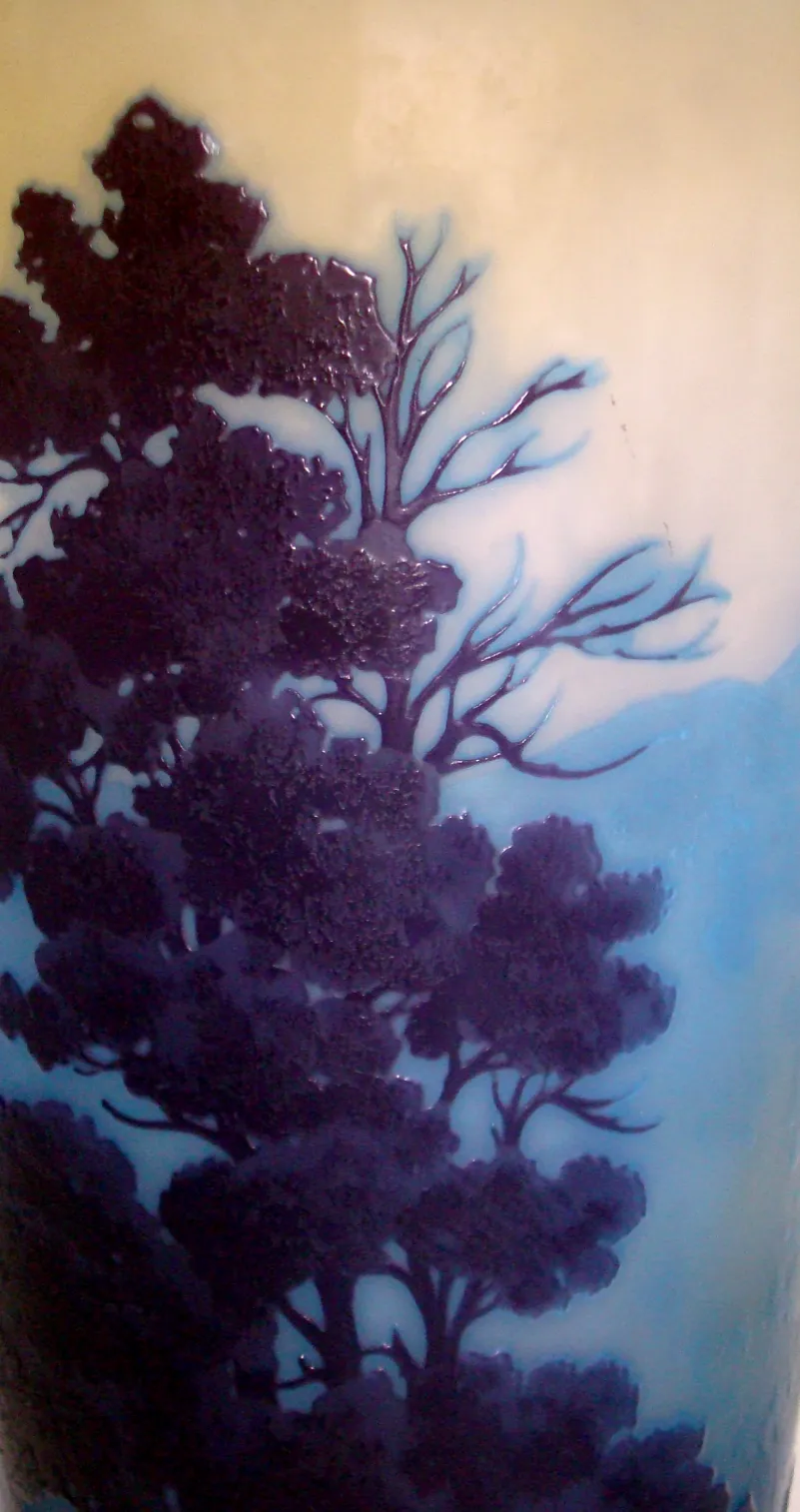 Glass signed Gallé with tree design in blue and purple tones.