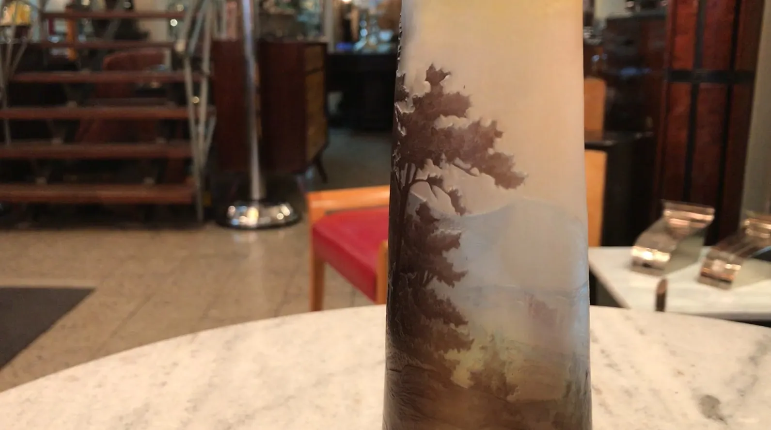 Signed Gallé glass with natural landscape, in an antique setting.