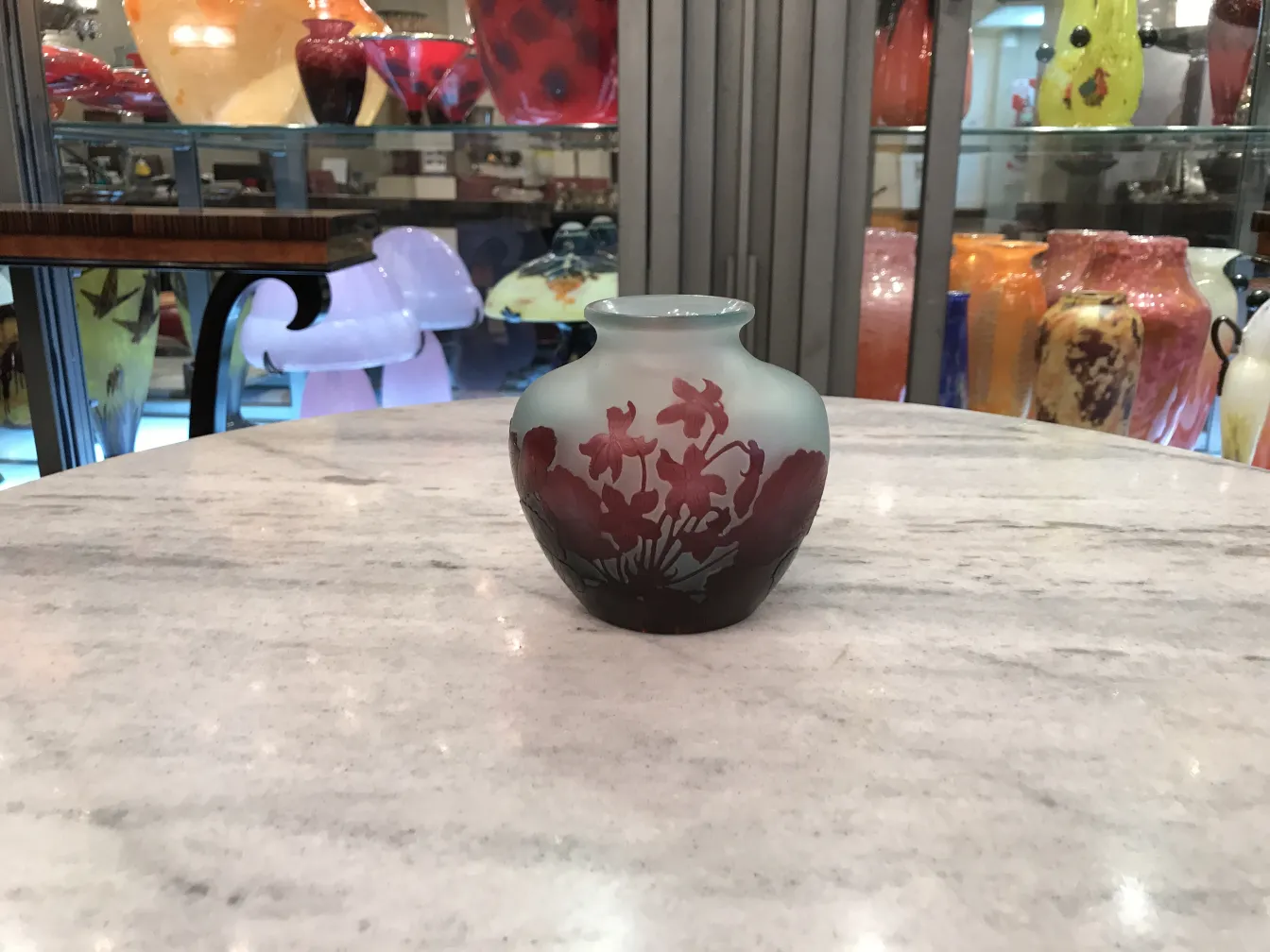 piccolo vaso in vetro firmato Gallé su tavolo, sfondo colorato