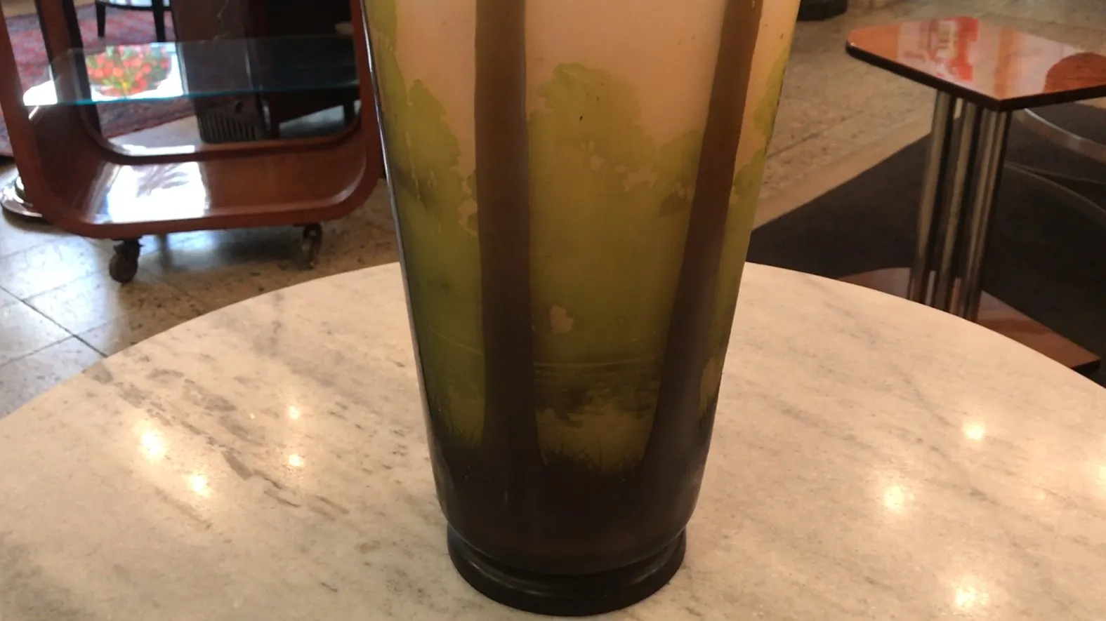 Antique signed glass by Gallé with elegant designs in a cozy setting.