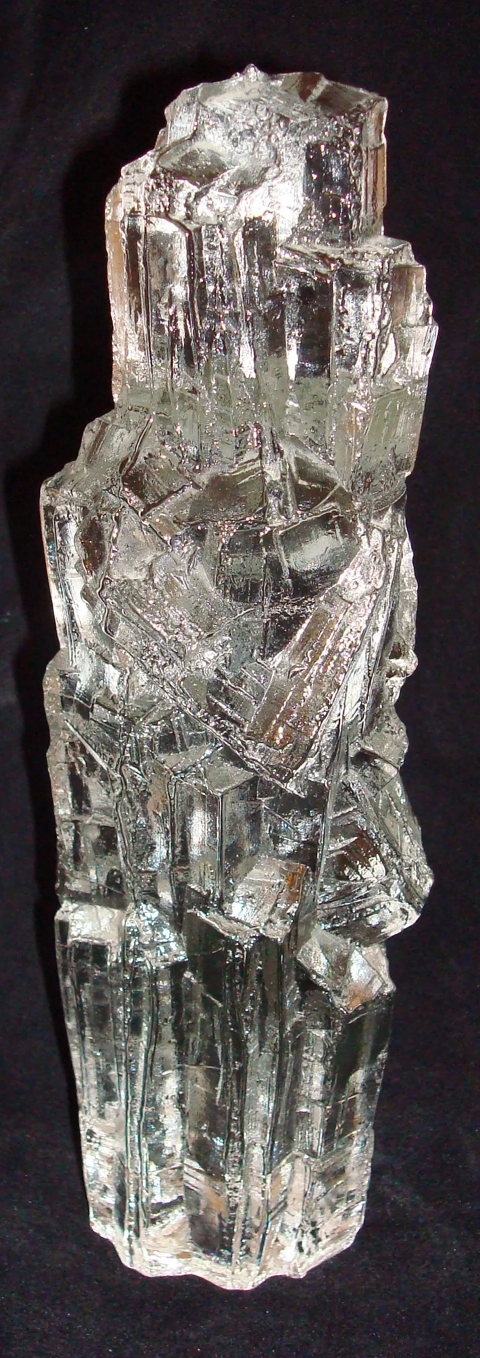 Signed glass with irregular shapes, black background.