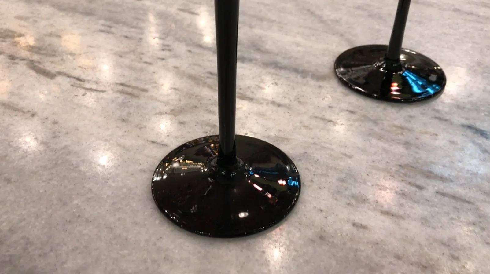 Vidro assinado com base preta, antiguidade em um ambiente iluminado.