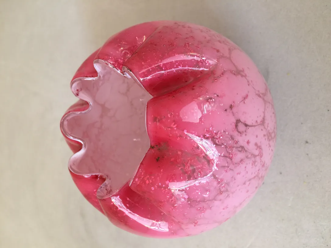 signed glass in pink tones with decorative design