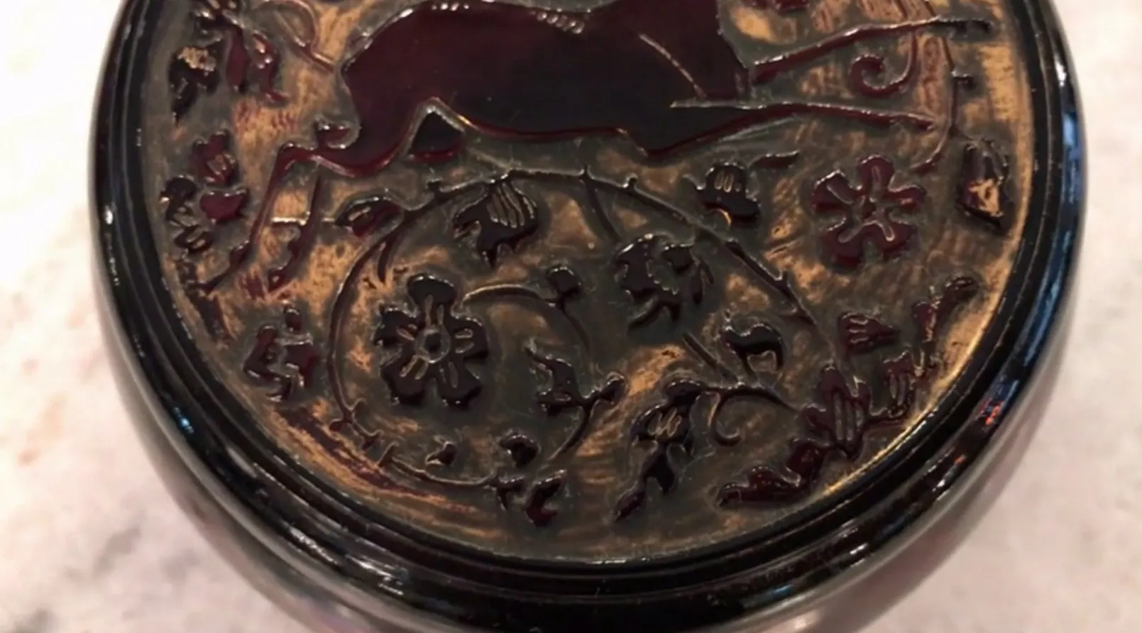 Antique signed glass with floral design and intricate details.