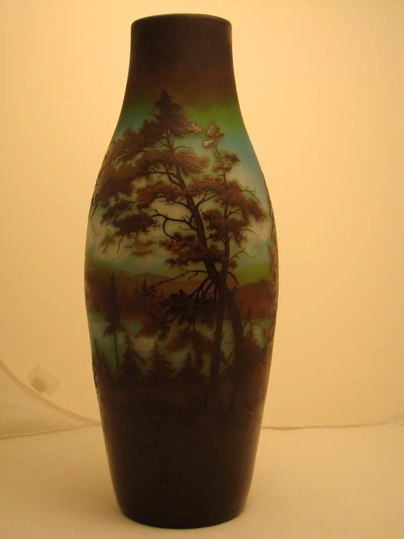 Antique vase with illuminated landscape in brown and blue hues.