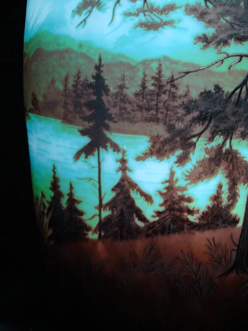 signed glass featuring a landscape in green and brown tones