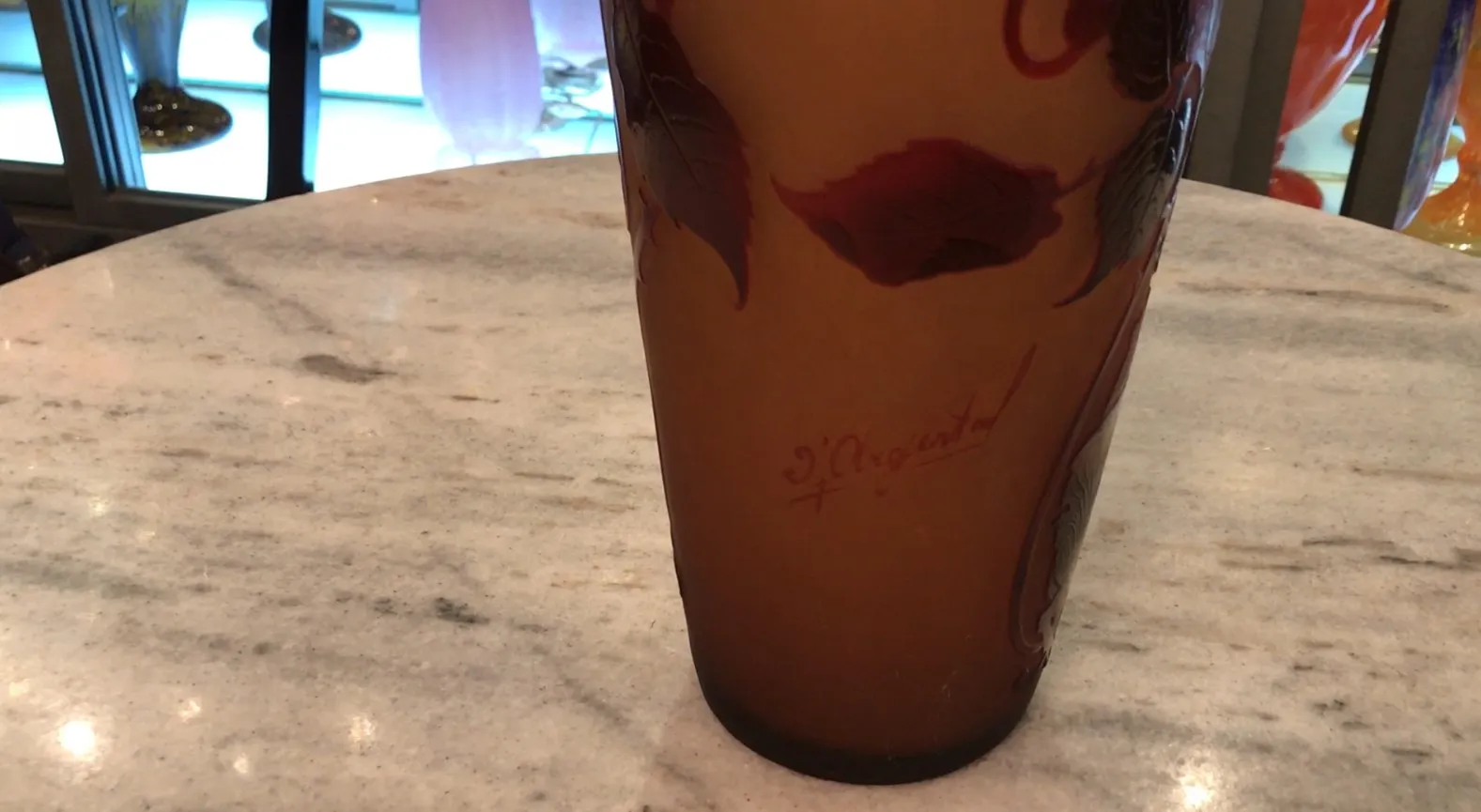 signed glass D'Argental with decorative leaves on light background