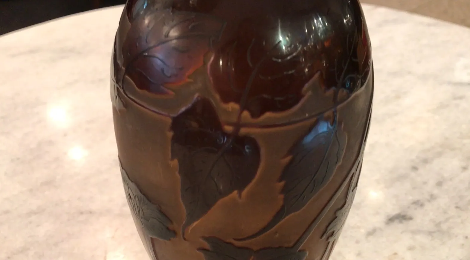 Antique glass with etched leaves from D'Argental in dark hues.