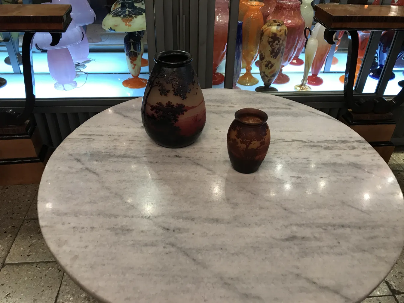 two antique vases signed d'argental on a table