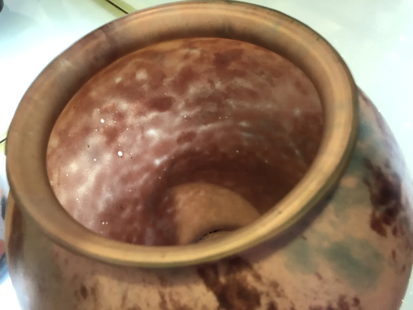 Signed Lorrain glass with soft tones inside, in an antique setting.