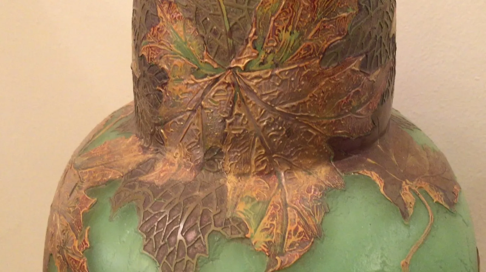 Antique signed glass Legras adorned with raised leaf details.