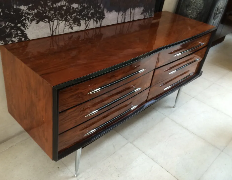 antique bedside table with a glossy finish and four elegant drawers in a cozy setting.