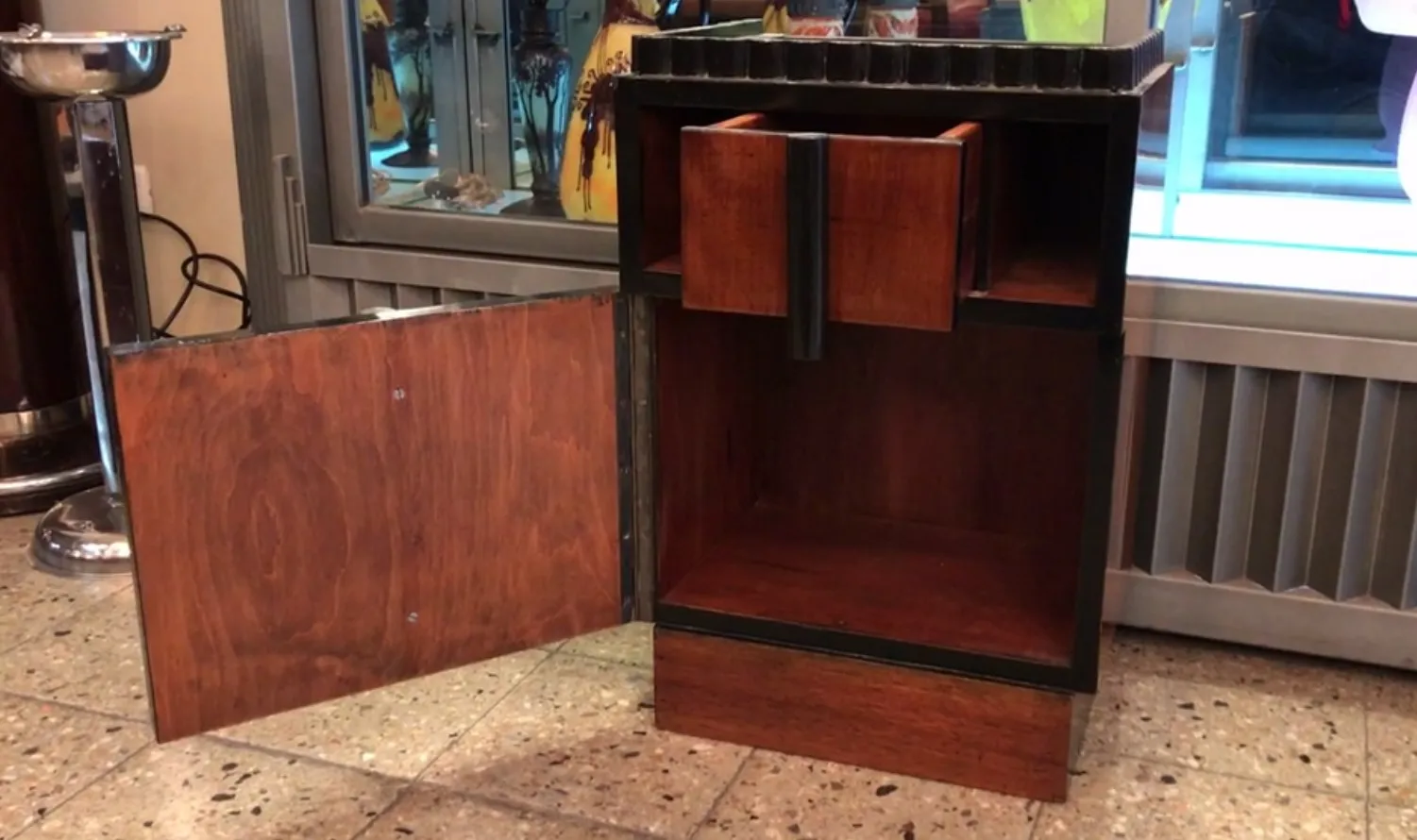 table de chevet antique avec tiroirs et porte décorative.