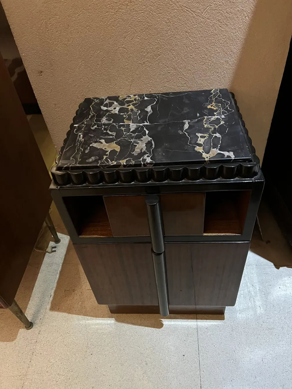 mesa de luz antiga com design intricado, em um ambiente acolhedor