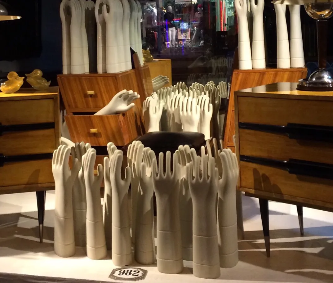 mesas de luz antiguas, decoradas con manos blancas como tema, en ambiente divertido