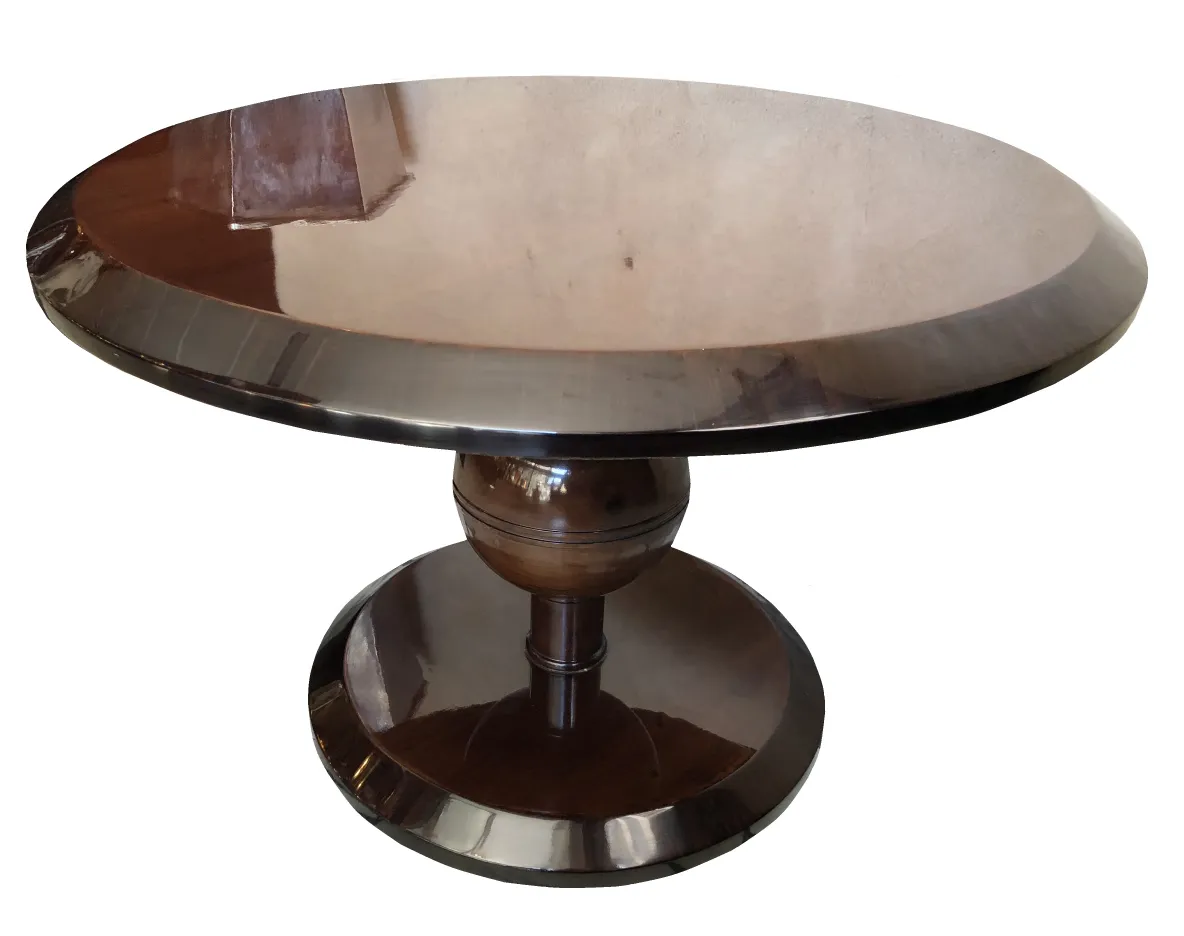 Antique round coffee table with polished pedestal, decorative elements