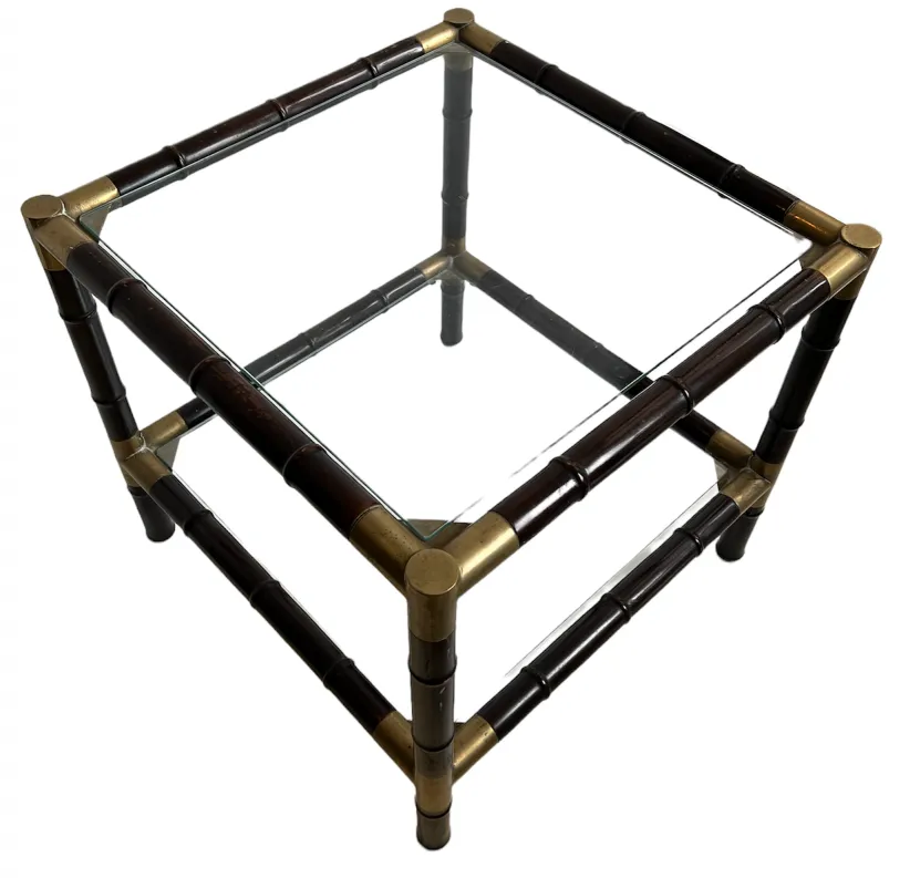 Table basse antique avec structure claire et dessus en verre dans un cadre classique.