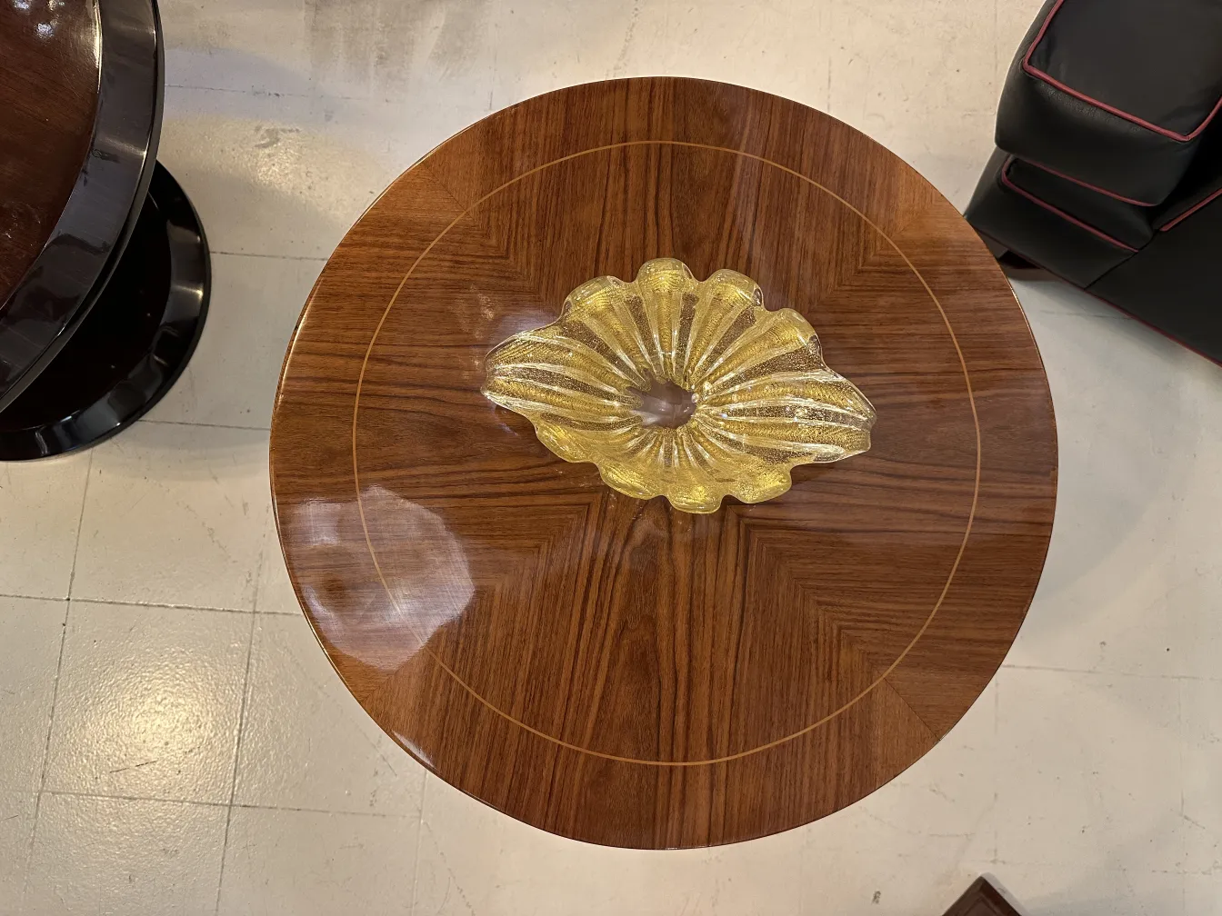 Antiker kleiner Tisch mit einem gelben Dekorationsgegenstand in der Mitte und kompliziertem Design.