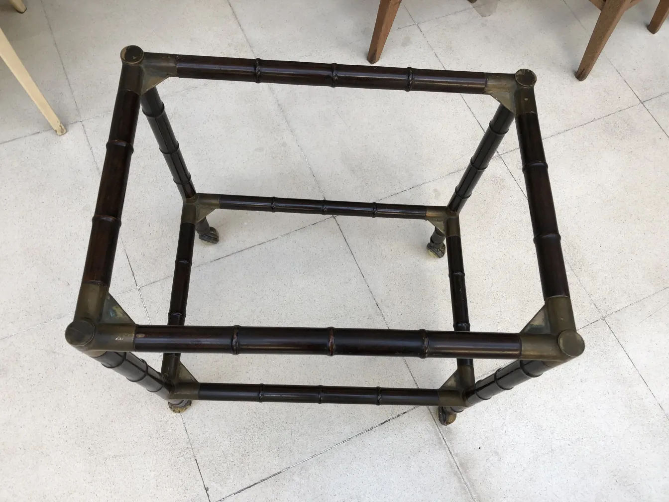 Antique small table with rounded corners, surrounded by other furniture.