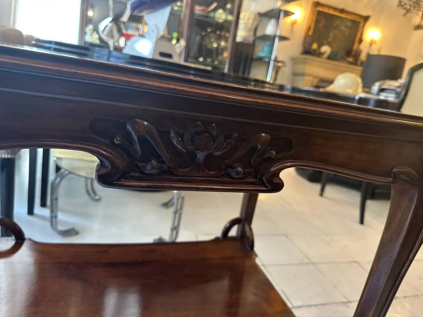 Antique small table with carved details in a classic setting.