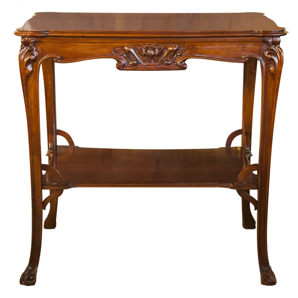 Antique small table featuring floral details at the front, side view.