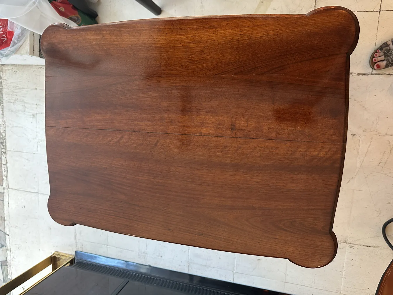 Antique small table with rounded shape, cozy ambiance